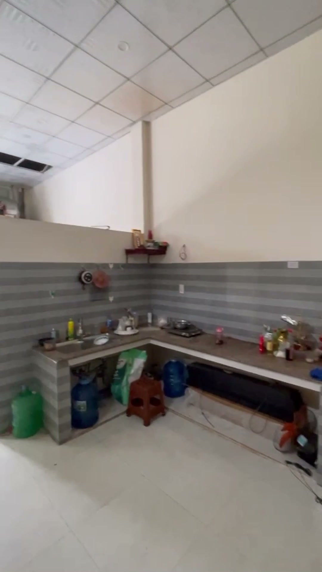 Khu bếp ốp gạch phía sau nhà cấp 4 mặt tiền Phan Châu Trinh Tam Kỳ, có bệ bếp và cửa sổ lấy sáng