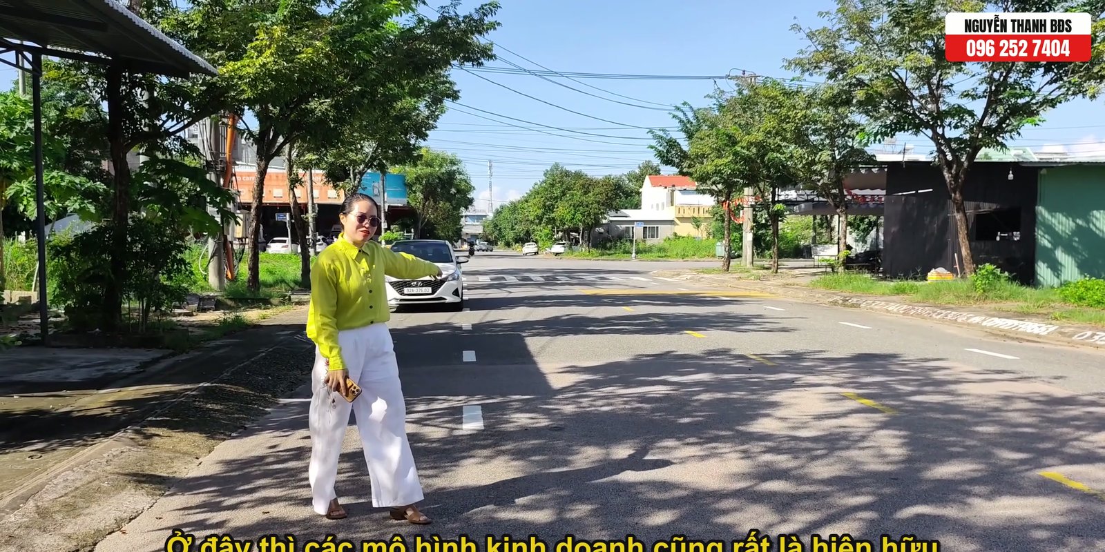 Nguyễn Thanh đứng trên đường Phan Khôi giới thiệu lô đất, hai bên đường đã có cơ sở kinh doanh